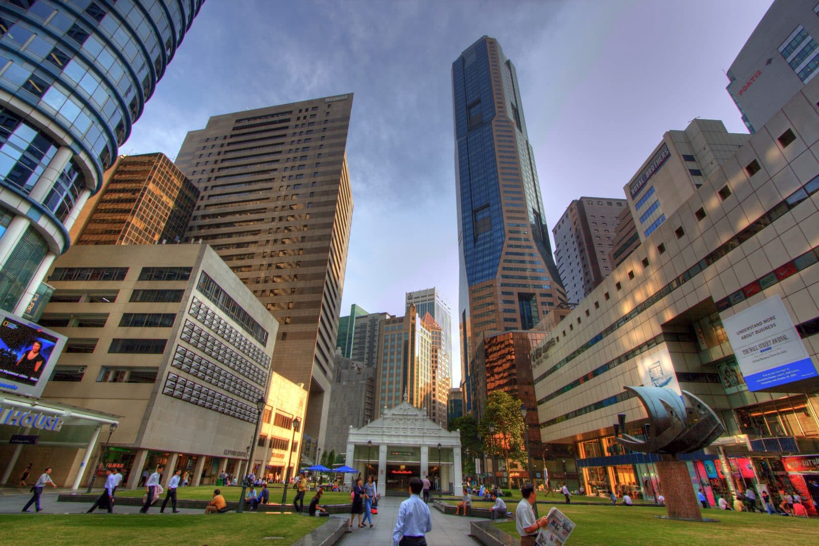 Menara pejabat di sekitar Raffles Place di Singapura dilihat dari dataran di bawah, dengan orang ramai melintasi ruang terbuka